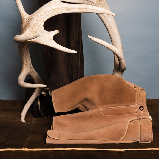 Lederhose auf Braunem Untergrund, neben Hirschgeweih